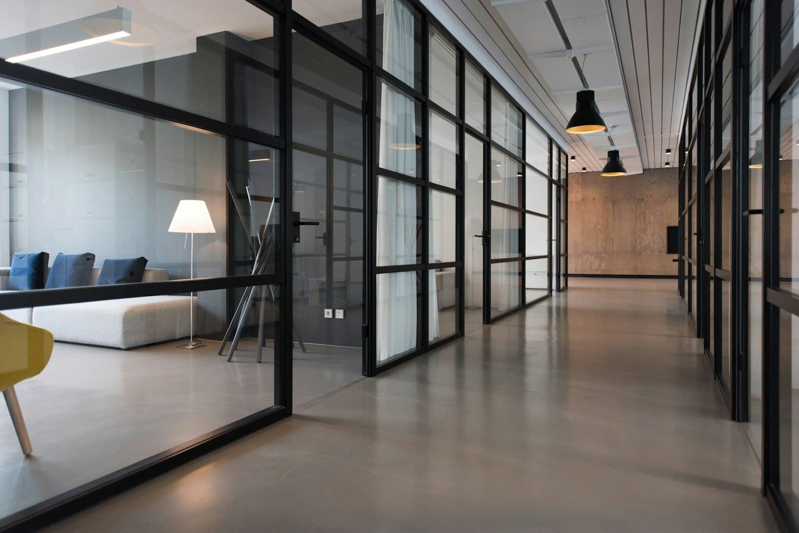 A bright open-plan studio with long shared desks and monitors, of the kind Apoliums works from in Indore